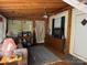 Relaxing screened porch with wooden ceiling and comfortable seating at 201 Deer Park Rd, Mount Gilead, NC 27306