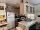 Galley kitchen with white appliances and breakfast bar at 201 Deer Park Rd, Mount Gilead, NC 27306
