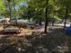 A wooded campsite with picnic tables and a fire pit at 201 Deer Park Rd, Mount Gilead, NC 27306
