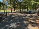 Gravel campsite with picnic table and fire pit at 201 Deer Park Rd, Mount Gilead, NC 27306