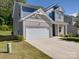 Two-story house with gray and beige siding, white garage door, and landscaping at 111 Fosters Glen Pl, Mooresville, NC 28115