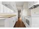 Kitchen hallway view with white cabinets and hardwood floors at 1010 E Franklin St, Monroe, NC 28112