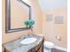 Elegant powder room with marble vanity and decorative mirror at 6615 Old Magnolia Ln, Mint Hill, NC 28227