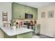 Stylish kitchen with light green cabinets, quartz countertops and a breakfast bar at 1123 Golden Maple Ln, Chester, SC 29706