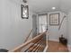 Upstairs hallway with modern light fixture and wood railing at 1664 Old Charlotte Rd, Concord, NC 28027