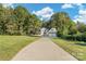 Long driveway leading to a two-story home and detached garage at 4194 Pointe Norman Dr, Sherrills Ford, NC 28673