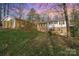 Brick house with a sunroom addition and a sloping yard at 681 Pine Bluff Cir, Kannapolis, NC 28081
