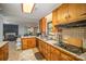 Bright kitchen features wood cabinets, tile floors, and a view into the living area at 681 Pine Bluff Cir, Kannapolis, NC 28081