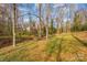 Wooded backyard with creek and bridge, offering privacy at 681 Pine Bluff Cir, Kannapolis, NC 28081