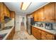 Galley kitchen with wood cabinets and stainless steel appliances at 681 Pine Bluff Cir, Kannapolis, NC 28081