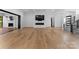 Spacious living room with hardwood floors, fireplace, and access to outdoor deck at 13702 Sage Thrasher Ln, Charlotte, NC 28278
