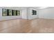 Bright bedroom with hardwood floors and multiple windows at 13702 Sage Thrasher Ln, Charlotte, NC 28278