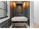 Elegant powder room with marble vanity and geometric wallpaper at 13702 Sage Thrasher Ln, Charlotte, NC 28278