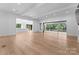 Open concept living area with hardwood floors and views to kitchen and deck at 13702 Sage Thrasher Ln, Charlotte, NC 28278