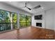 Relaxing screened porch with hardwood flooring, fireplace and lake views at 13702 Sage Thrasher Ln, Charlotte, NC 28278