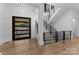 Bright entryway with modern staircase and hardwood floors at 13702 Sage Thrasher Ln, Charlotte, NC 28278