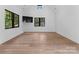 Spacious bonus room with hardwood floors and large windows offering natural light at 13702 Sage Thrasher Ln, Charlotte, NC 28278