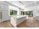 Modern kitchen with large island, white cabinets and lake views at 13702 Sage Thrasher Ln, Charlotte, NC 28278