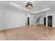 Finished basement with hardwood floors and a staircase leading to the upper level at 13702 Sage Thrasher Ln, Charlotte, NC 28278