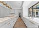 Open kitchen with white cabinetry, marble countertops and large island at 13702 Sage Thrasher Ln, Charlotte, NC 28278