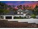 Luxury home exterior at dusk, showcasing architecture and landscaping at 13702 Sage Thrasher Ln, Charlotte, NC 28278