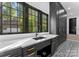 Well-appointed laundry room, featuring dark cabinetry and quartz countertops at 13702 Sage Thrasher Ln, Charlotte, NC 28278