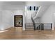 Bright entryway with modern staircase and hardwood floors at 13702 Sage Thrasher Ln, Charlotte, NC 28278