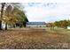 Spacious backyard with scattered leaves and a firepit at 418 Summer Ridge Rd, Stanley, NC 28164