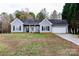 Gray vinyl-sided house with a white garage door and landscaping at 418 Summer Ridge Rd, Stanley, NC 28164