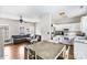 Open kitchen with white cabinets, stainless steel appliances and dining area at 418 Summer Ridge Rd, Stanley, NC 28164