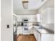 L-shaped kitchen with white cabinets and stainless steel appliances at 418 Summer Ridge Rd, Stanley, NC 28164
