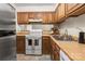 Modern kitchen with stainless steel appliances and wood cabinets at 1606 Sharon W Rd # 35, Charlotte, NC 28210