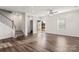 Living room with hardwood floors, stairs and half bath at 504 Cranford Dr, Pineville, NC 28134