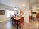 Bright dining room features a wooden table with seating for six and a view into the kitchen at 104 Aberdeen Dr, Troutman, NC 28166