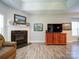 Relaxing living room with a fireplace, large TV, and comfortable seating at 104 Aberdeen Dr, Troutman, NC 28166