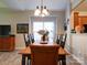 Bright dining room features a wooden table with seating for six and a view into the kitchen at 104 Aberdeen Dr, Troutman, NC 28166