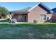 Brick home's backyard with patio, grill, and fenced area at 104 Aberdeen Dr, Troutman, NC 28166