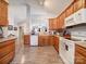 Open kitchen boasts oak cabinets, white appliances, and views to dining area at 104 Aberdeen Dr, Troutman, NC 28166