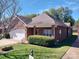 Brick ranch home with attached garage and landscaping at 104 Aberdeen Dr, Troutman, NC 28166