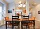 Bright dining room features a wooden table with seating for six and a view into the kitchen at 104 Aberdeen Dr, Troutman, NC 28166