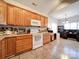 Spacious kitchen with oak cabinets, white appliances, and a breakfast nook at 104 Aberdeen Dr, Troutman, NC 28166