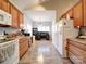 Modern kitchen with oak cabinets, white appliances and a center island at 104 Aberdeen Dr, Troutman, NC 28166