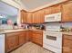 Well-equipped kitchen featuring oak cabinets and white appliances at 104 Aberdeen Dr, Troutman, NC 28166