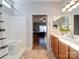 Bathroom with double vanity, shower, and view of bedroom at 104 Aberdeen Dr, Troutman, NC 28166