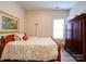 Bedroom with wood floors, full bed, and wardrobe at 104 Aberdeen Dr, Troutman, NC 28166