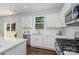 Modern kitchen features white cabinets, stainless steel appliances, and a window at 115 N Main St, Huntersville, NC 28078