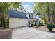 Two-story house with white siding, two-car garage, and driveway at 14312 Crown Harbor Dr, Charlotte, NC 28278