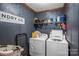 Laundry room with washer, dryer, and storage shelves at 120 Forest St, Rockwell, NC 28138