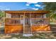House exterior featuring a wooden covered porch and stairs at 120 Forest St, Rockwell, NC 28138