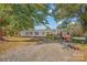 Ranch-style home with gravel driveway and mature trees at 120 Forest St, Rockwell, NC 28138